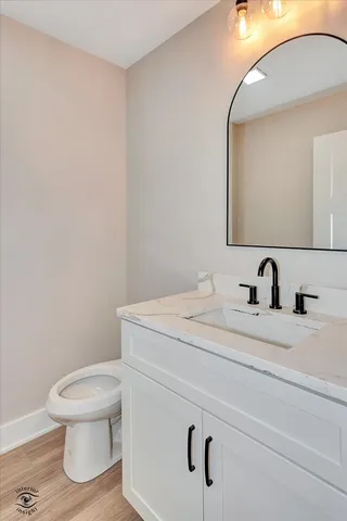 a bathroom with a toilet a sink and mirror