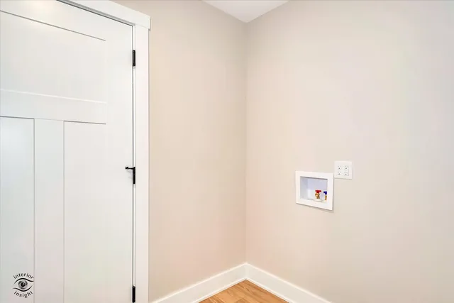 a view of a hallway with wooden floor and entryway