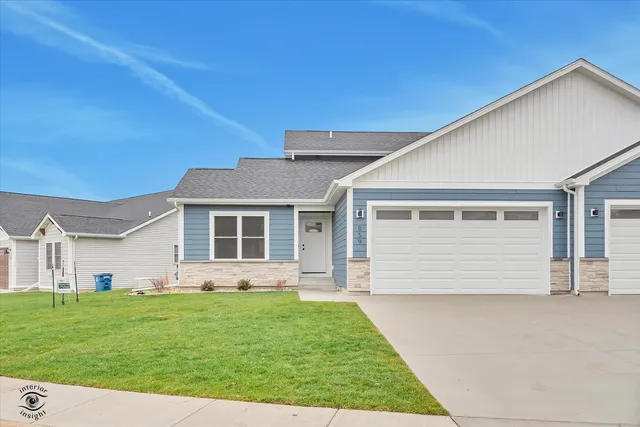 a front view of a house with a garden and yard