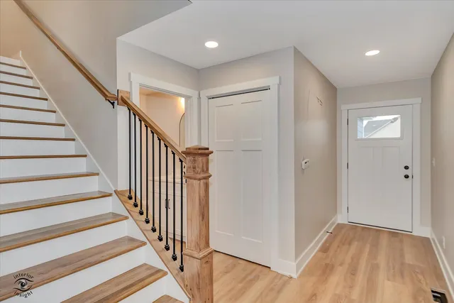 a view of a hallway with wooden floor and entryway