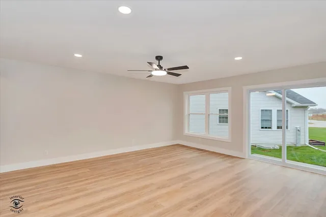 a view of a livingroom with a ceiling fan and window