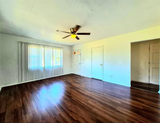 wooden floor in an empty room with a window