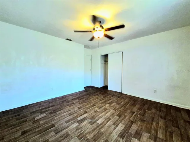 a view of walk in closet with wooden floor