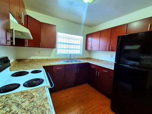 a kitchen with a sink stove and cabinets