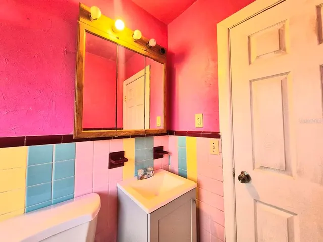 a view of an empty room with wooden floor and window