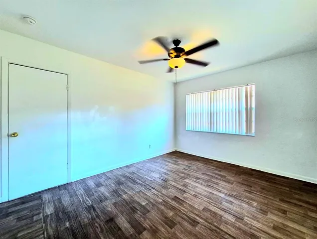 a view of a room with wooden floor