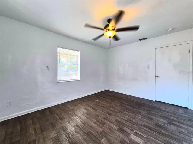 a view of a yard with yellow lighting