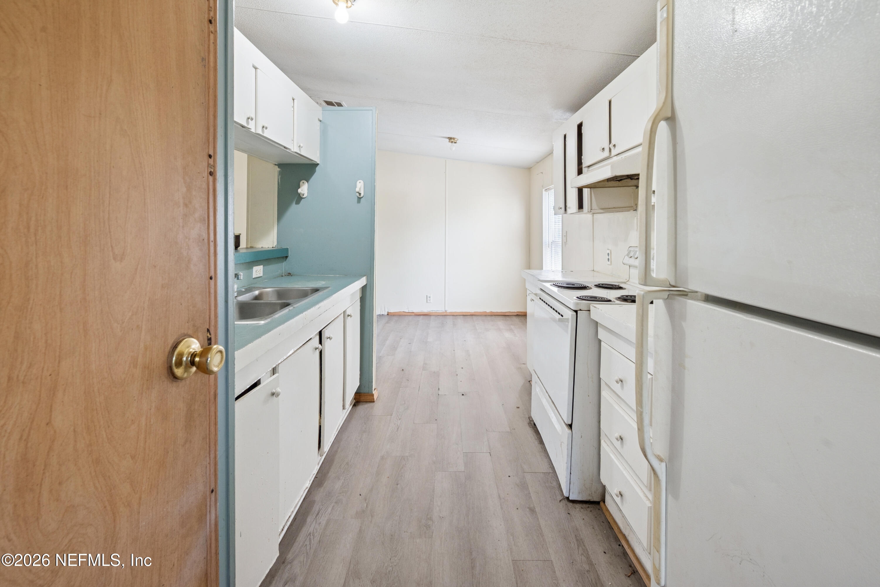 9860 State Rte 100 Starke, FL 32091 - Photo 13 of 24 a view of a hallway with wooden floor and staircase