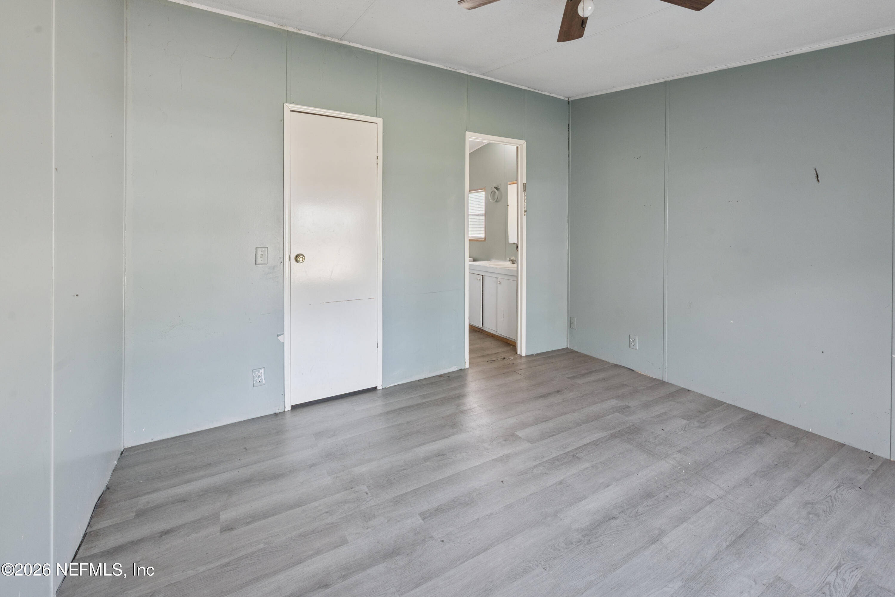9860 State Rte 100 Starke, FL 32091 - Photo 15 of 24 a view of an empty room with wooden floor and a window