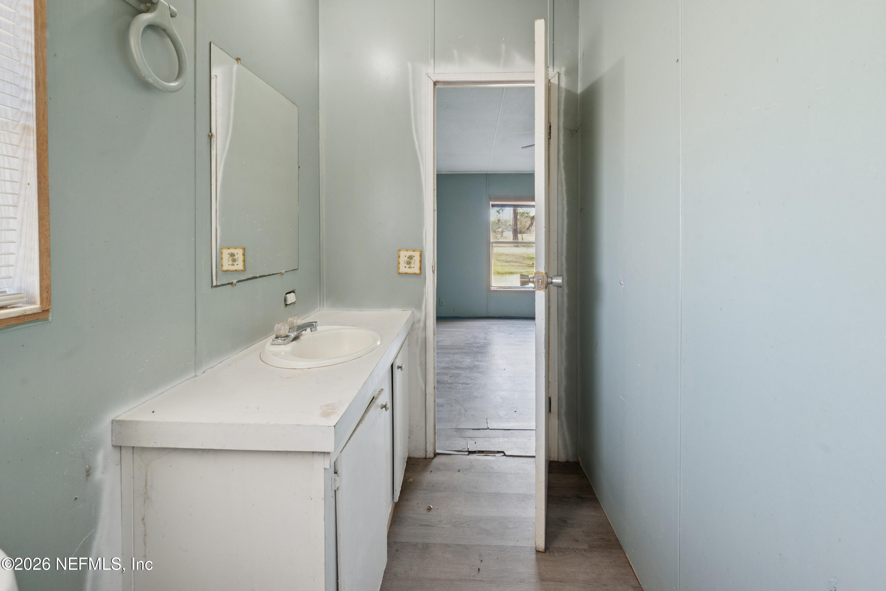 9860 State Rte 100 Starke, FL 32091 - Photo 16 of 24 a bathroom with a sink and a mirror