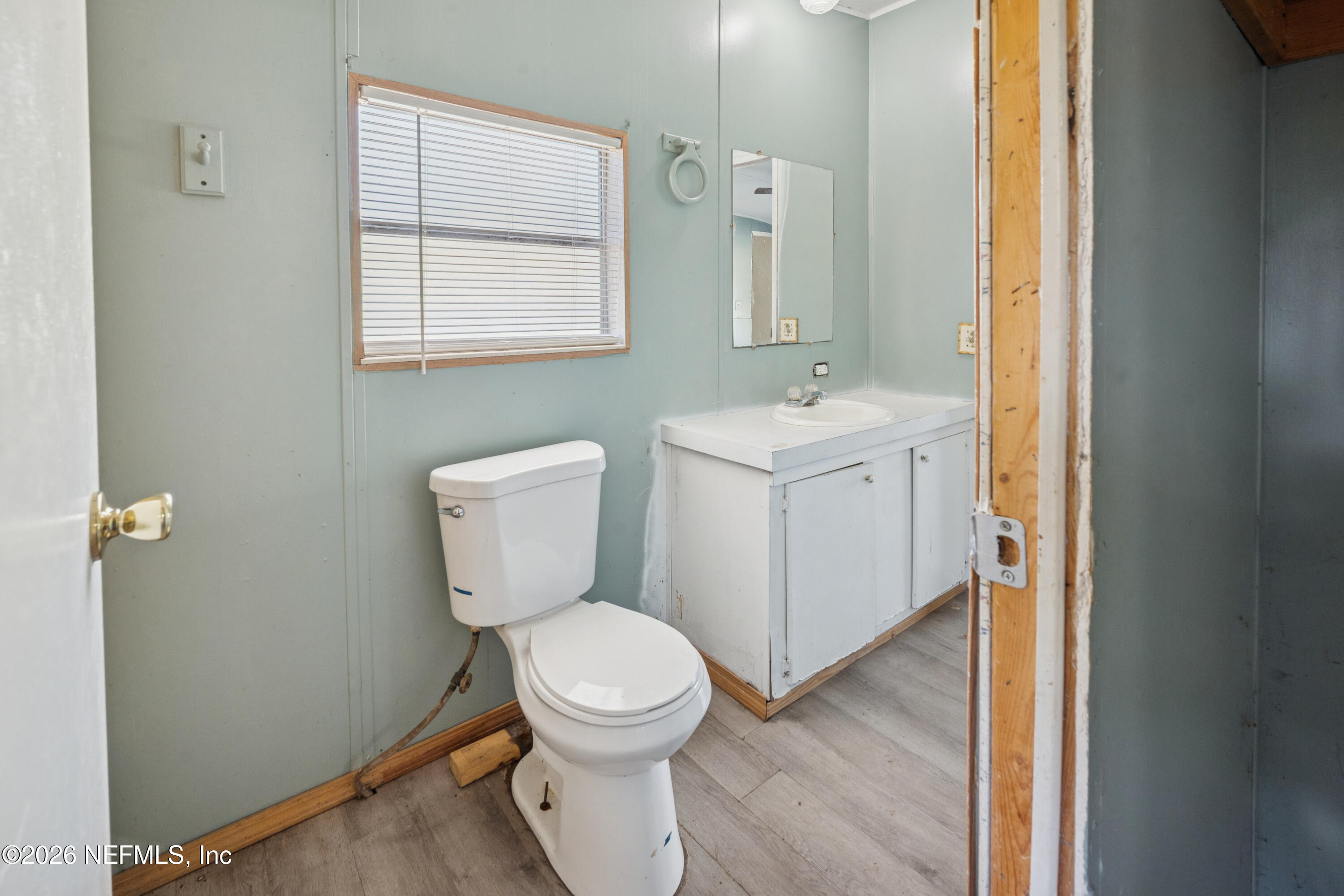 9860 State Rte 100 Starke, FL 32091 - Photo 17 of 24 a bathroom with a toilet sink and mirror