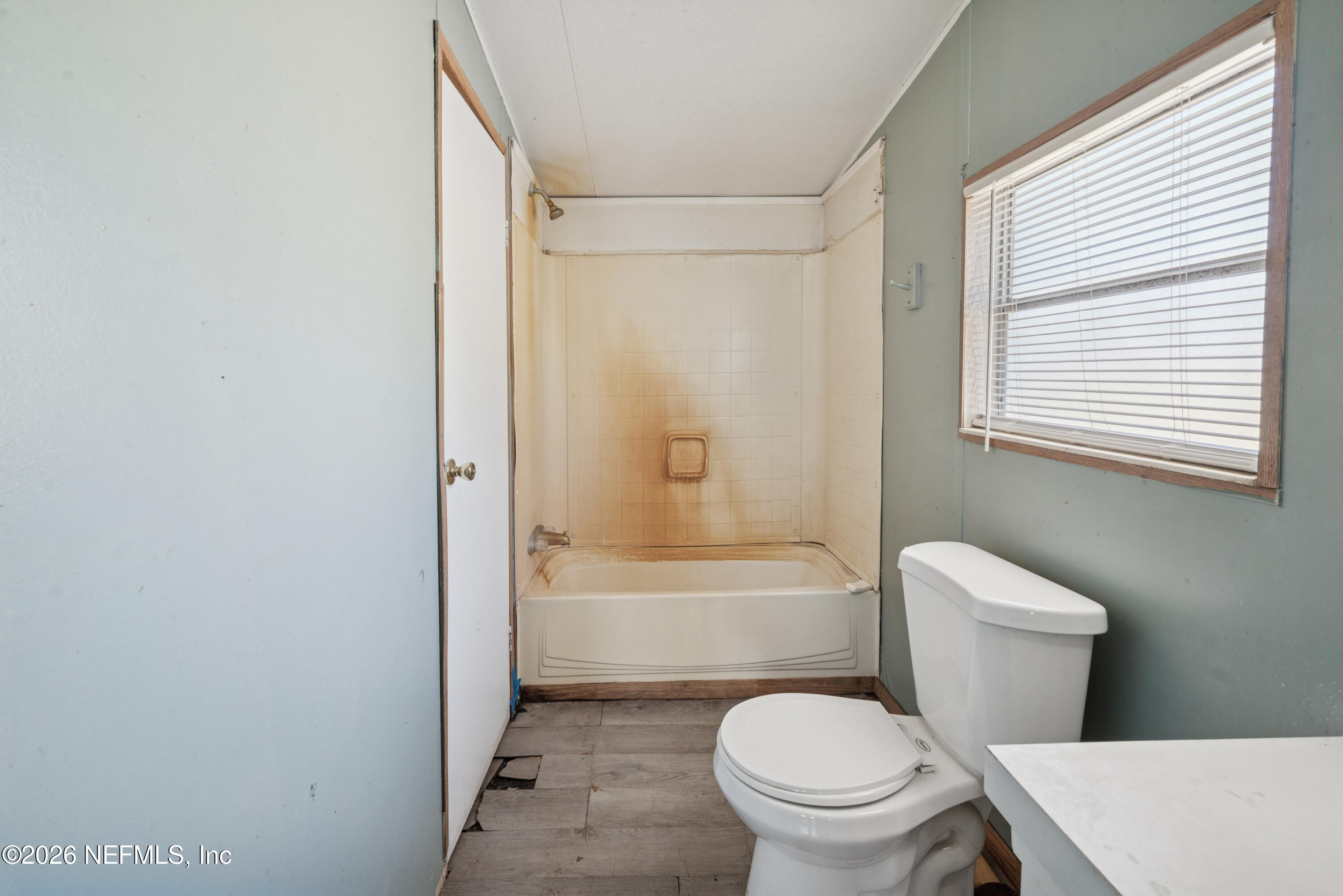 9860 State Rte 100 Starke, FL 32091 - Photo 18 of 24 a white toilet sitting next to a bath tub shower