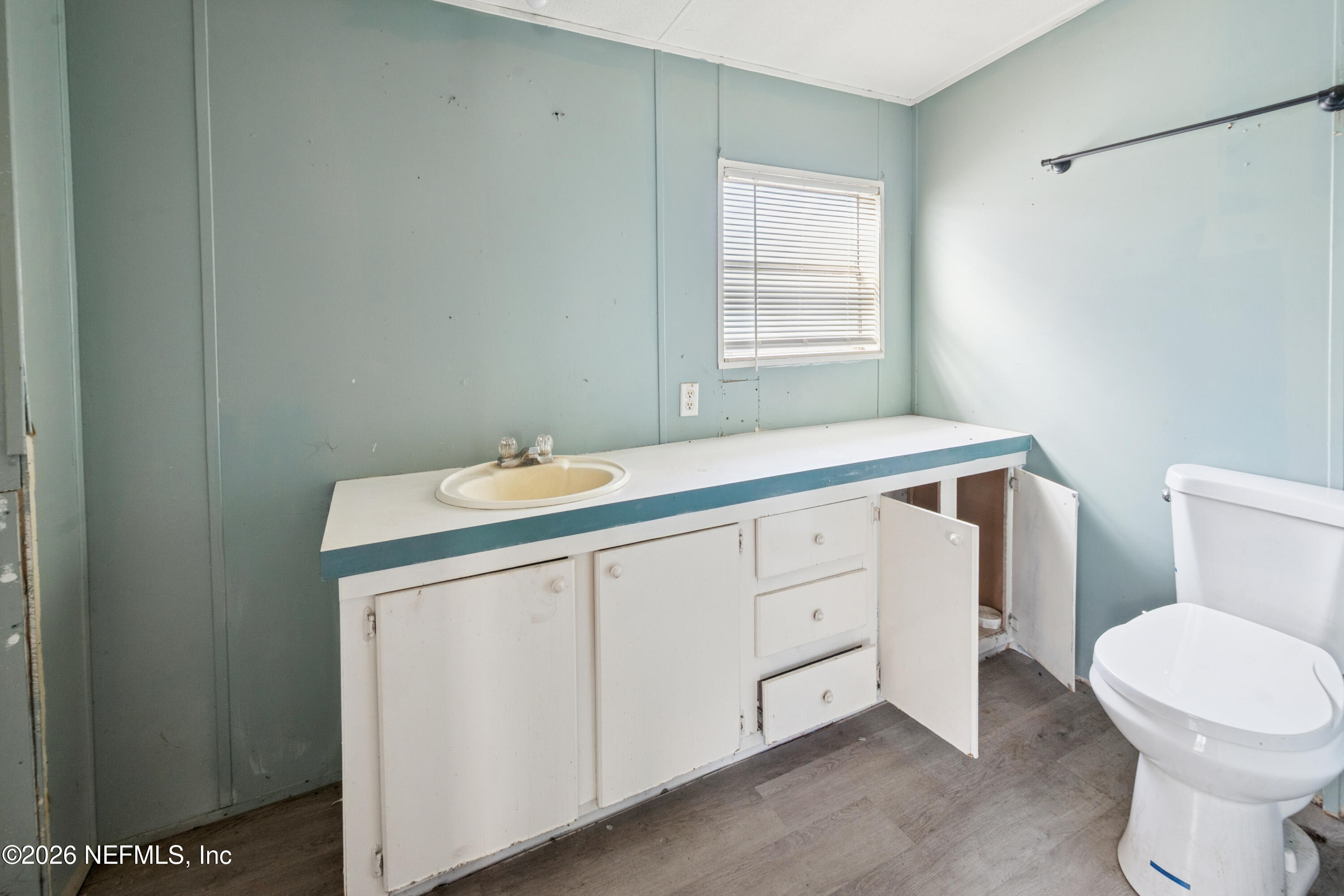 9860 State Rte 100 Starke, FL 32091 - Photo 21 of 24 a bathroom with a sink a toilet and window