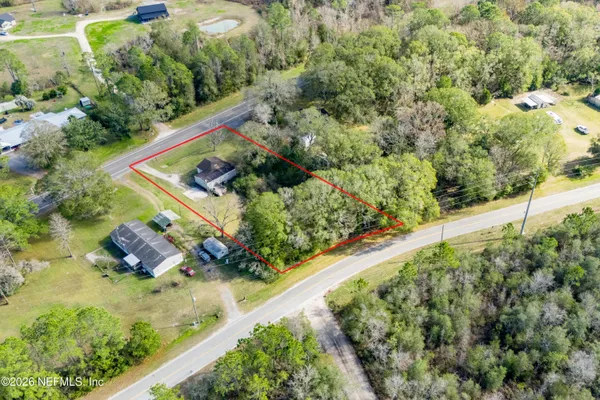 an aerial view of a house with a yard