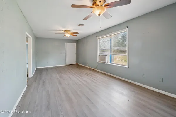 wooden floor in an empty room with a window