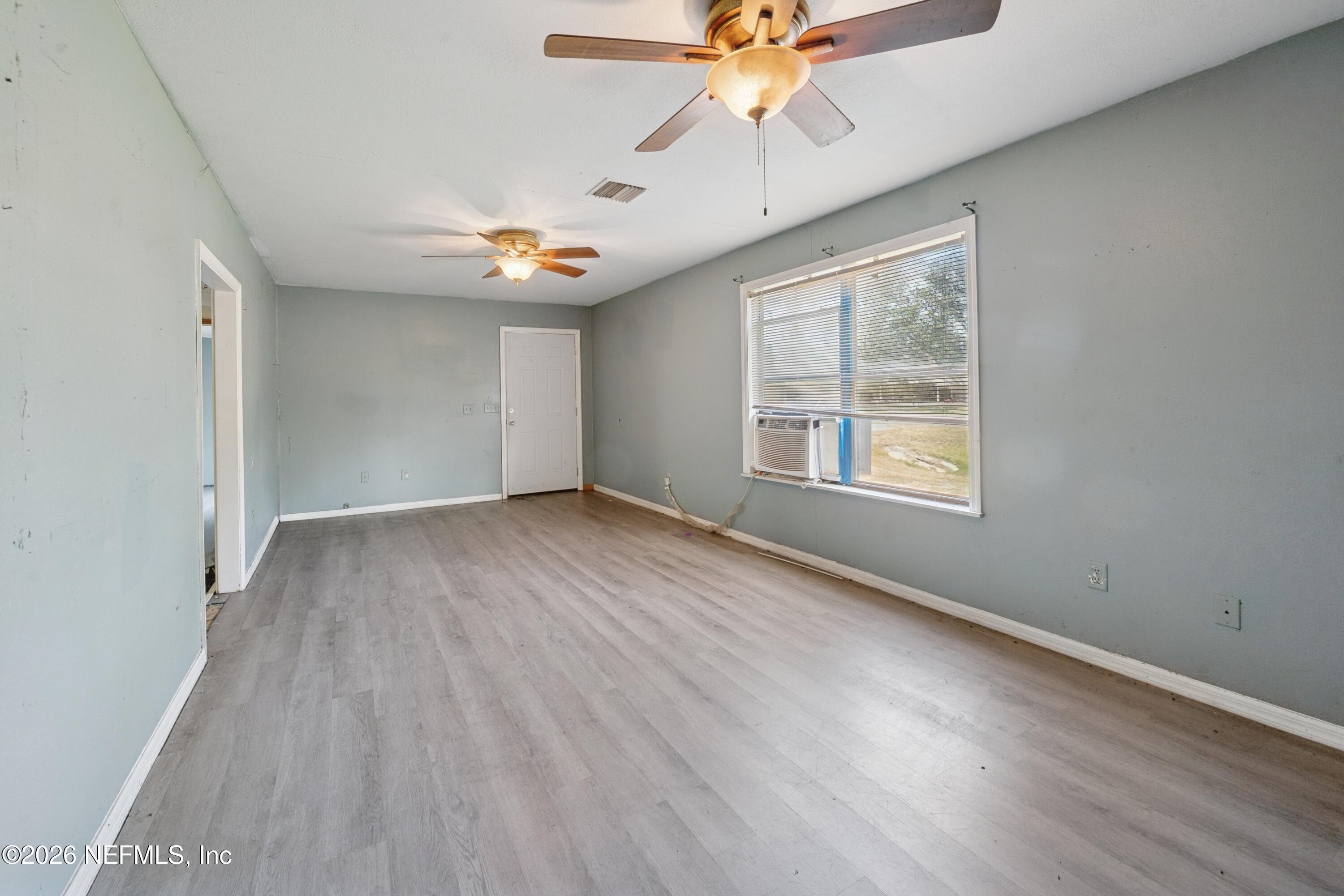 9860 State Rte 100 Starke, FL 32091 - Photo 6 of 24 wooden floor in an empty room with a window