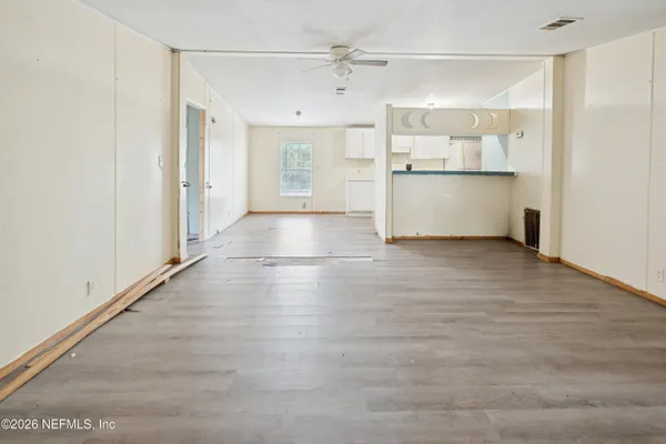 a view of a refrigerator in kitchen and wooden floor