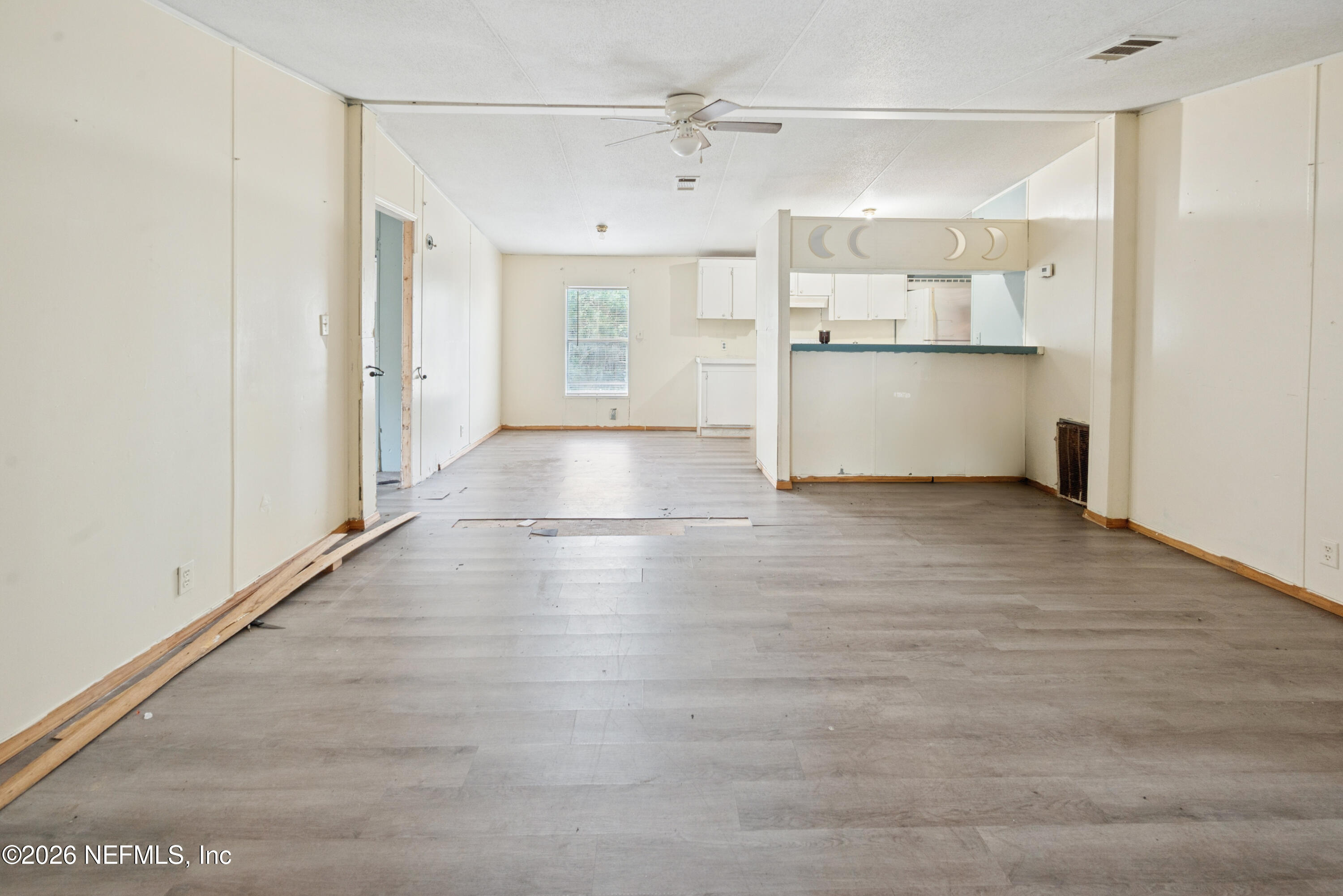 9860 State Rte 100 Starke, FL 32091 - Photo 8 of 24 a view of a refrigerator in kitchen and wooden floor