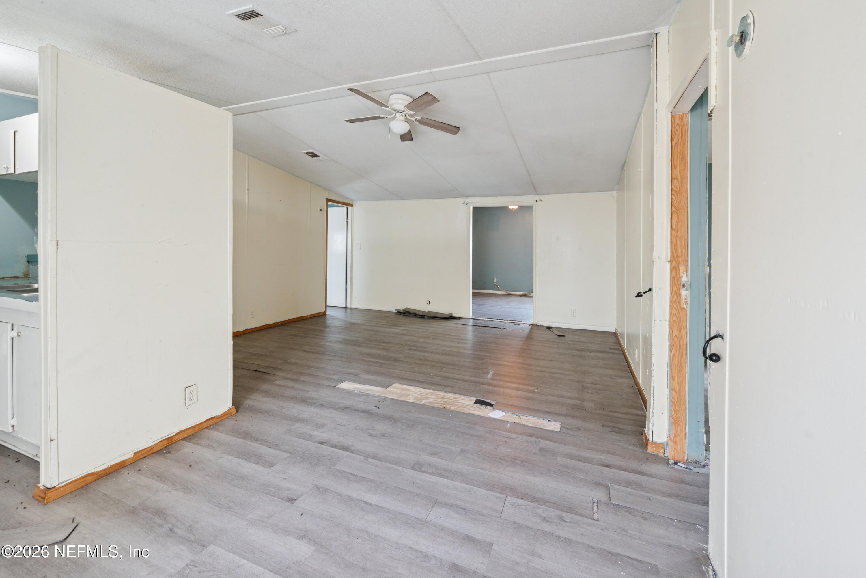 9860 State Rte 100 Starke, FL 32091 - Photo 9 of 24 an empty room with wooden floor and entryway