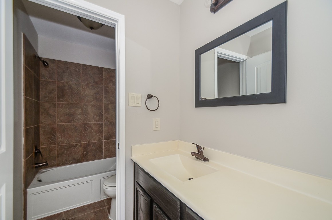 2646 Leopard Court Katy, TX 77449 - Photo 20 of 32 a bathroom with a sink a toilet and shower