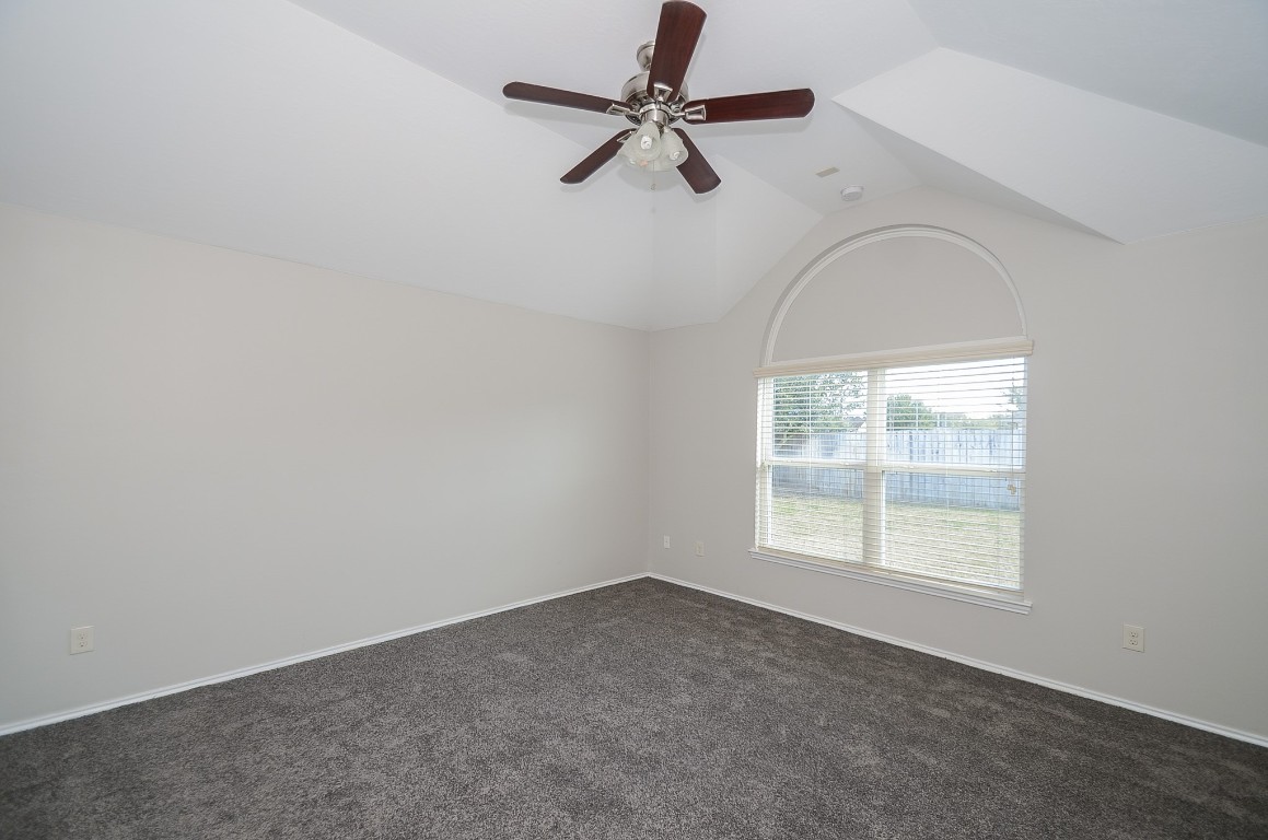 2646 Leopard Court Katy, TX 77449 - Photo 24 of 32 an empty room with windows and ceiling fan