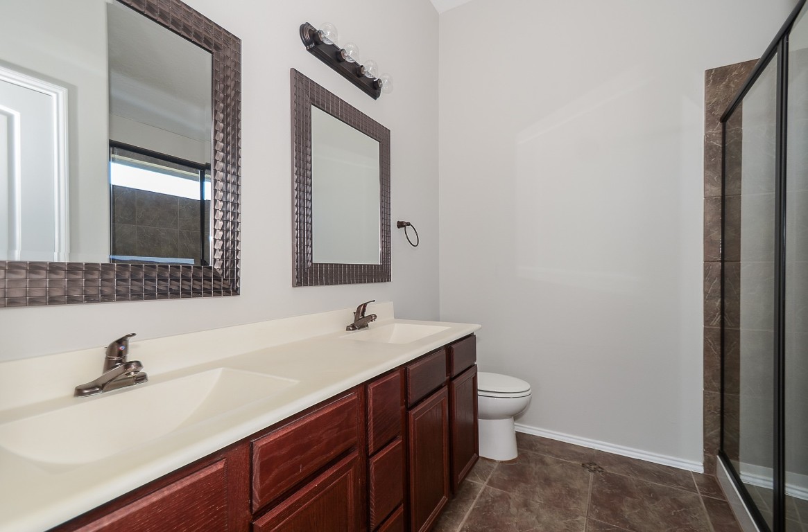 2646 Leopard Court Katy, TX 77449 - Photo 28 of 32 a bathroom with a sink and a mirror