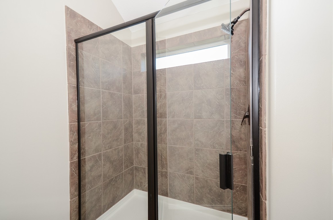 2646 Leopard Court Katy, TX 77449 - Photo 29 of 32 a bathroom with a glass shower door