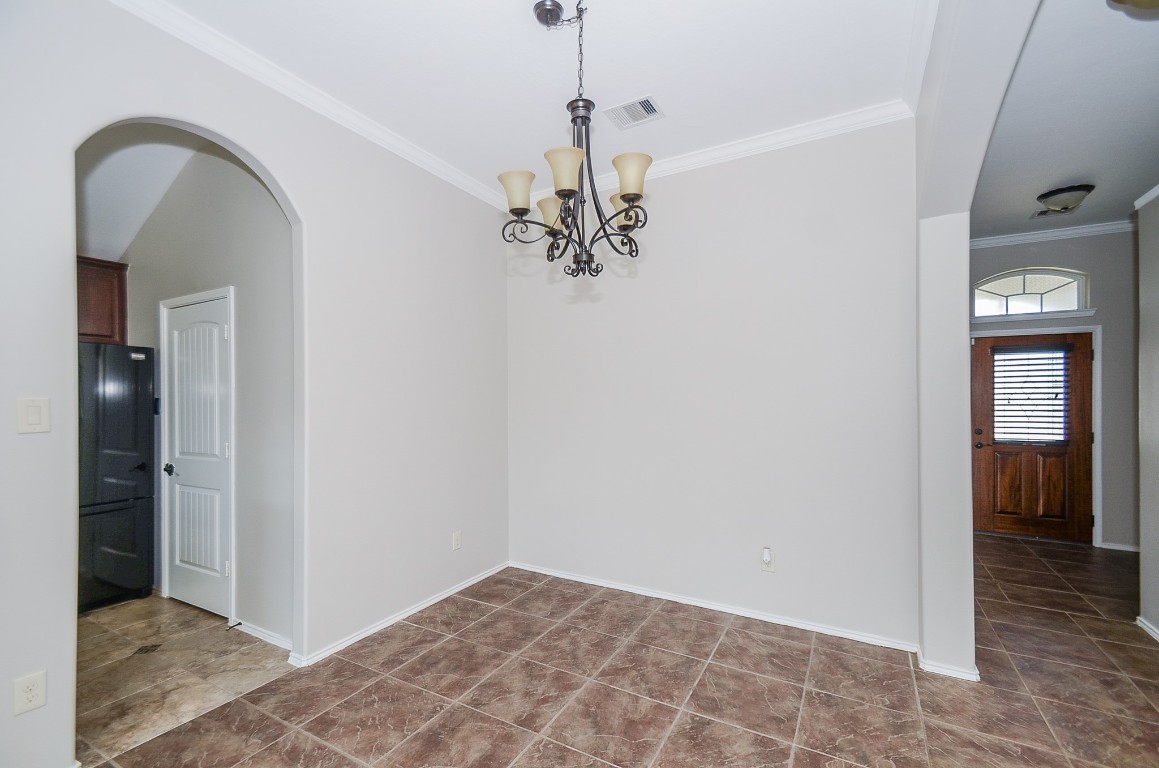 2646 Leopard Court Katy, TX 77449 - Photo 5 of 32 a view of a hallway with wooden floor and a chandelier