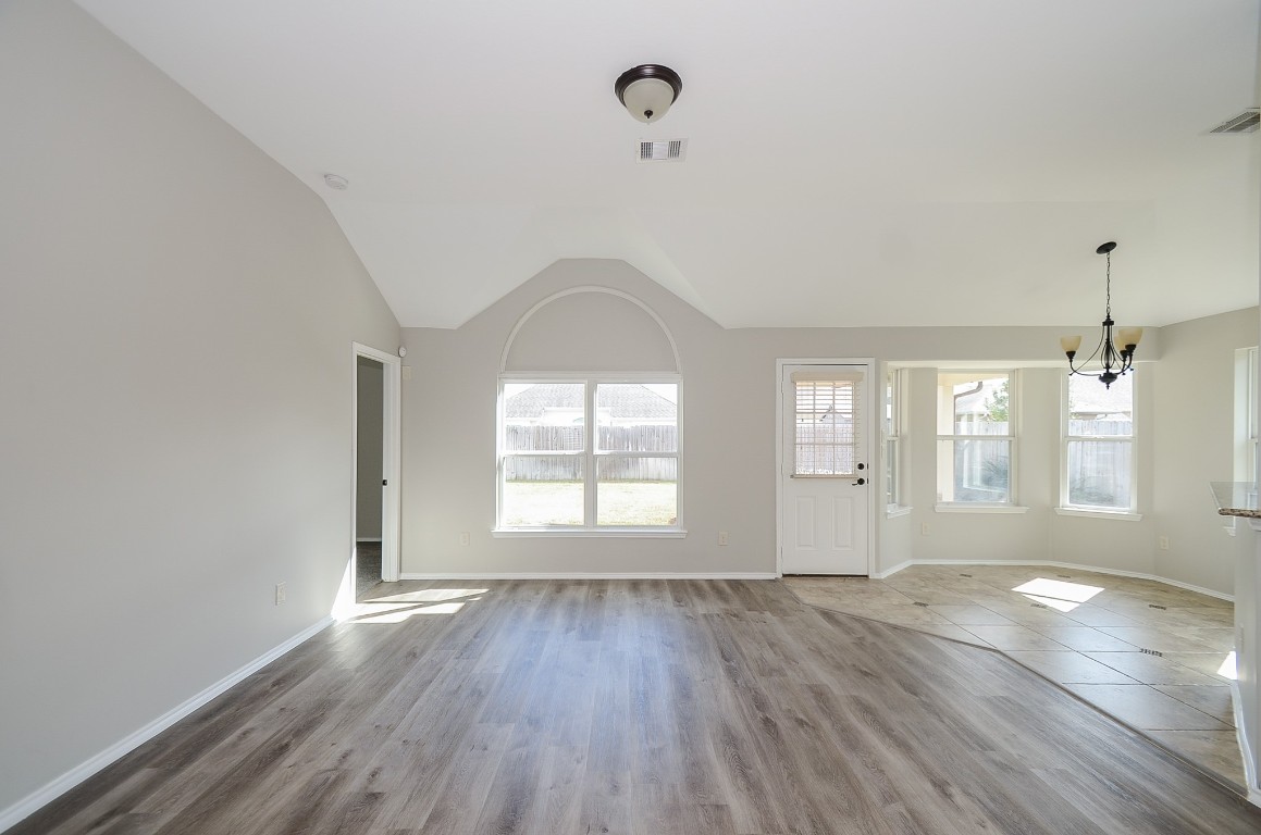 2646 Leopard Court Katy, TX 77449 - Photo 9 of 32 an empty room with wooden floor and windows