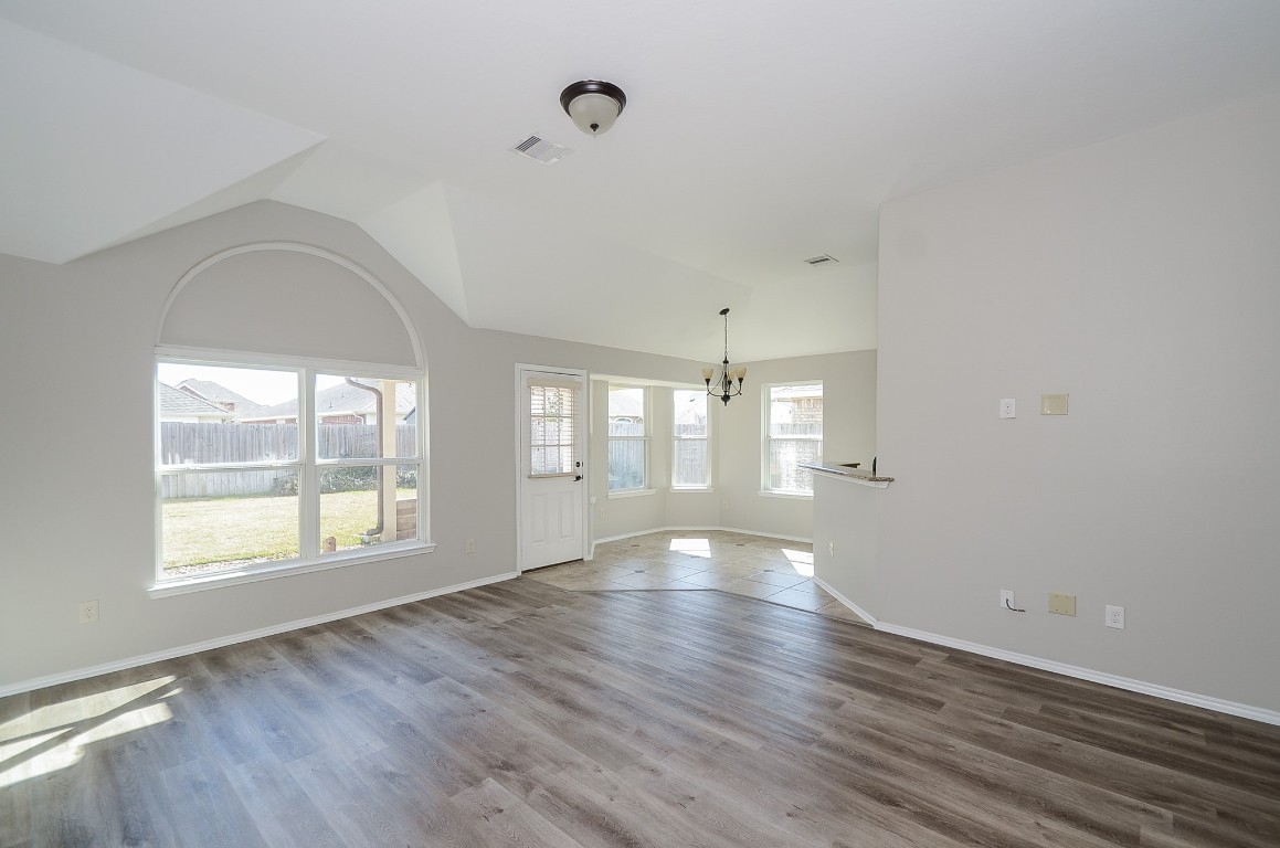 2646 Leopard Court Katy, TX 77449 - Photo 10 of 32 an empty room with wooden floor and windows