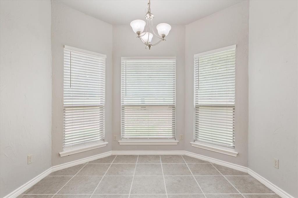 140 Oak Ridge Loop Whitney, TX 76692 - Photo 11 of 40 This room features a tiled floor, three windows with blinds, and a ceiling light fixture
