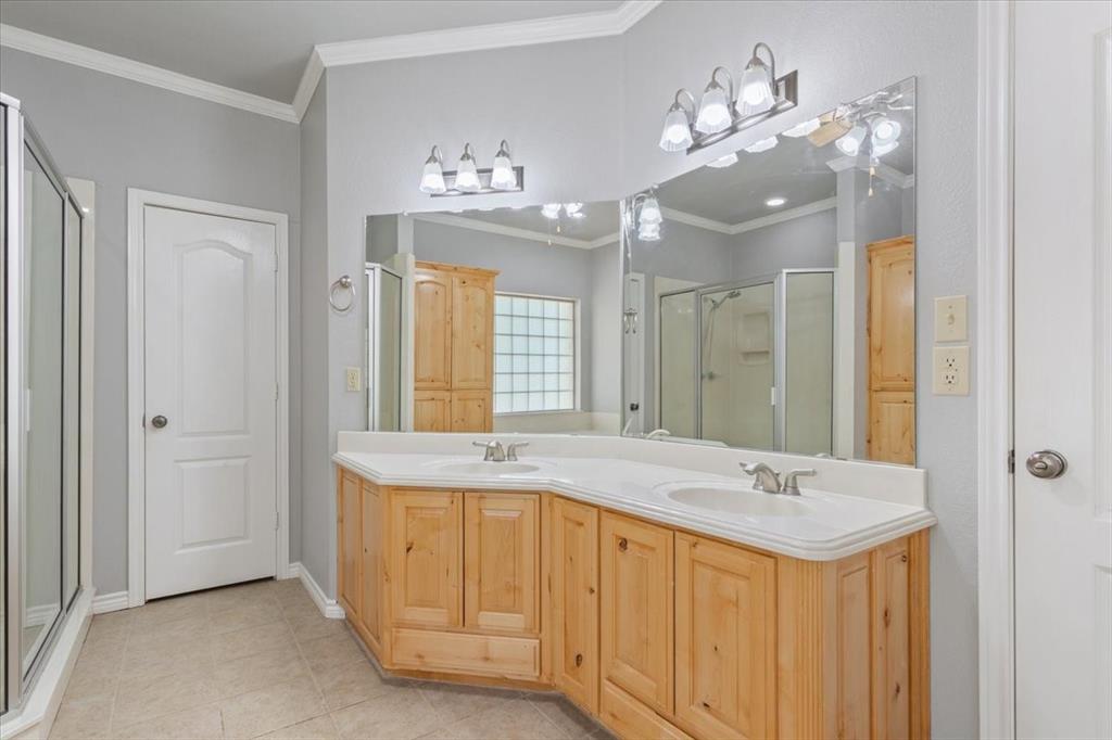 140 Oak Ridge Loop Whitney, TX 76692 - Photo 25 of 40 Bathroom featuring a dual vanity with light wood cabinetry, a large mirror, and overhead lighting