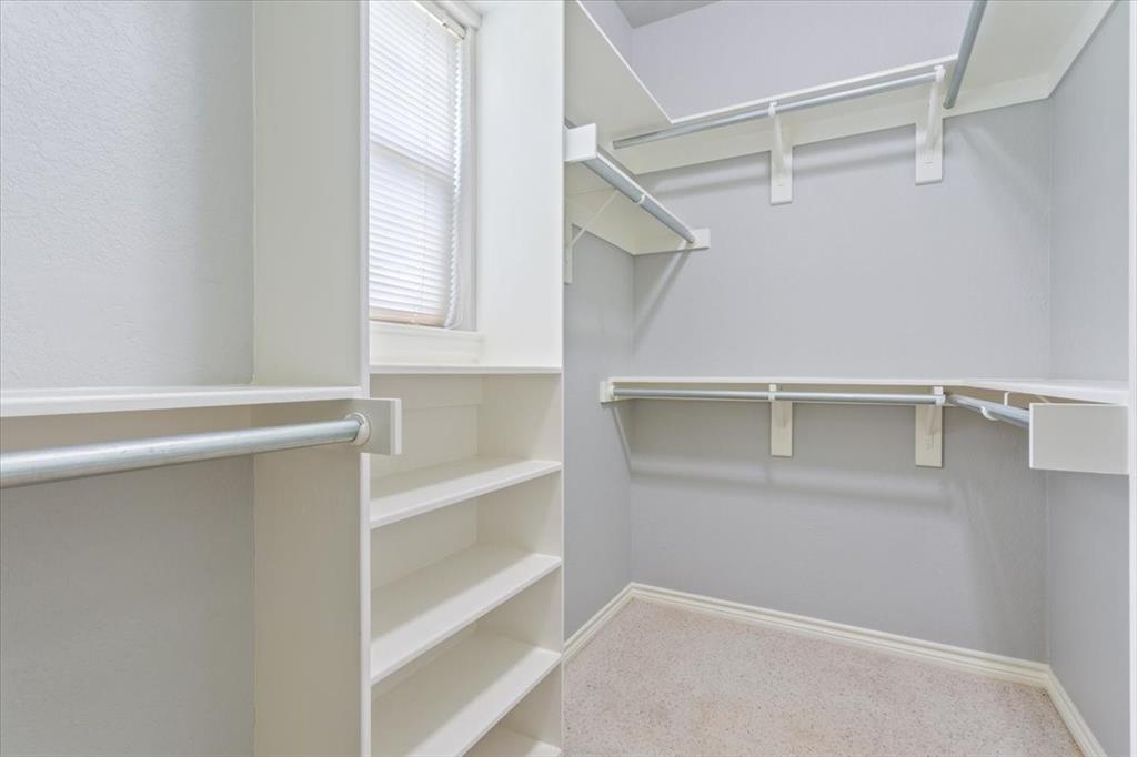 140 Oak Ridge Loop Whitney, TX 76692 - Photo 26 of 40 The property features a closet with built-in shelving, hanging rods, and a window for natural light