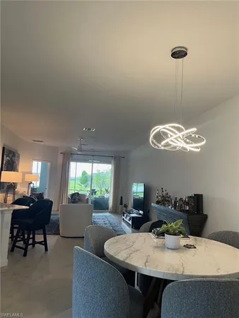 a view of a dining room with furniture and a chandelier