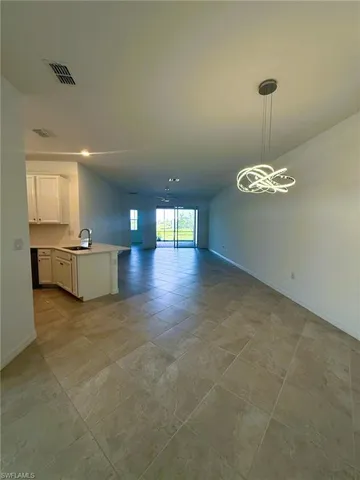 a view of a kitchen with a sink cabinets and a floor to ceiling window