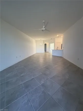 a view of empty room with windows and cabinet