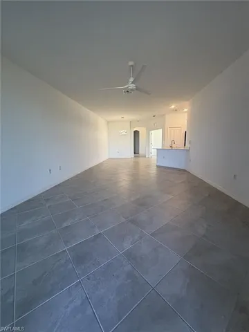 a view of empty room with windows and cabinet