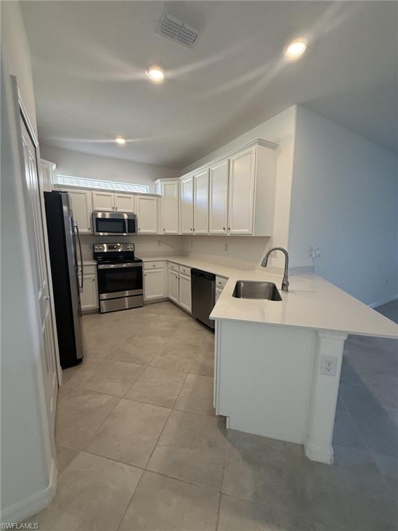 2648 Vine Avenue Naples, FL 34120 - Photo 7 of 20 a kitchen with kitchen island a sink stainless steel appliances and cabinets