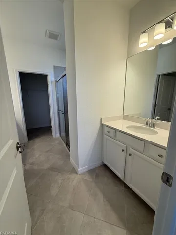 a spacious bathroom with a double vanity sink and a mirror