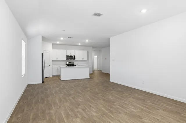 a view of a kitchen with a sink and a refrigerator