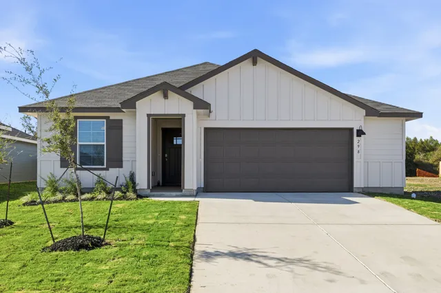 a front view of house with yard and green space