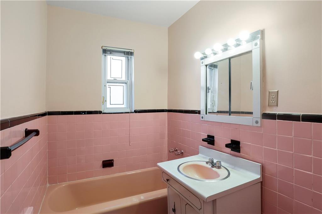 2815 Ave Y Brooklyn, NY 11235 - Photo 15 of 21 a bathroom with a sink a mirror and a bathtub