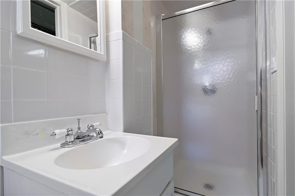 2815 Ave Y Brooklyn, NY 11235 - Photo 19 of 21 a bathroom with a sink and mirror