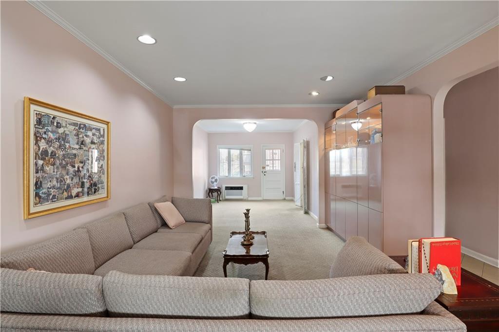 2815 Ave Y Brooklyn, NY 11235 - Photo 4 of 21 a living room with furniture and a large mirror