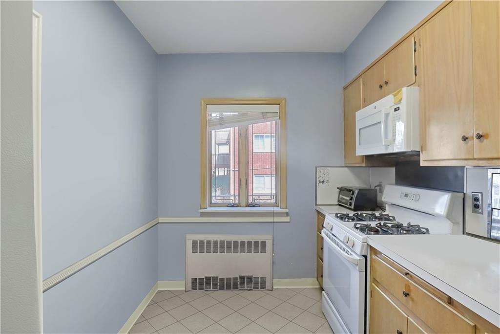 2815 Ave Y Brooklyn, NY 11235 - Photo 9 of 21 a kitchen with stainless steel appliances a refrigerator and a stove top oven