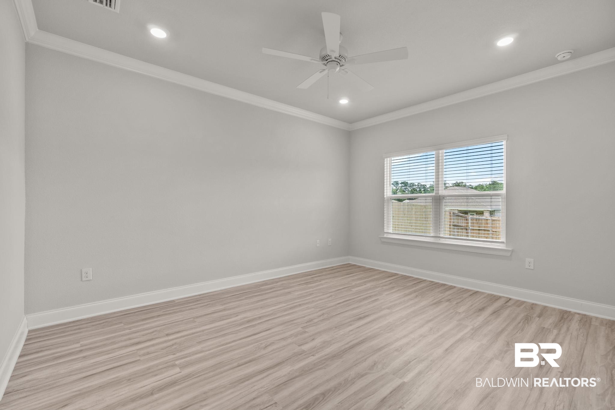 32125 Lyon Road Daphne, AL 36527 - Photo 10 of 70 Spacious room featuring wood-finish flooring, a ceiling fan, recessed lighting, and crown molding