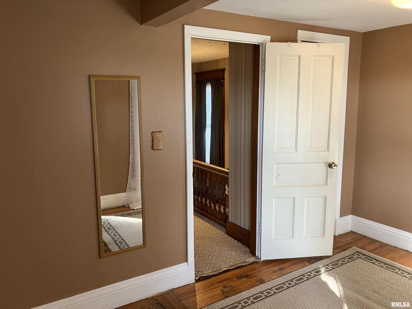 837 Beach Street Kewanee, IL 61443 - Photo 32 of 54 a view of a hallway with wooden floor and closet