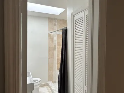 a bathroom with a toilet and a shower