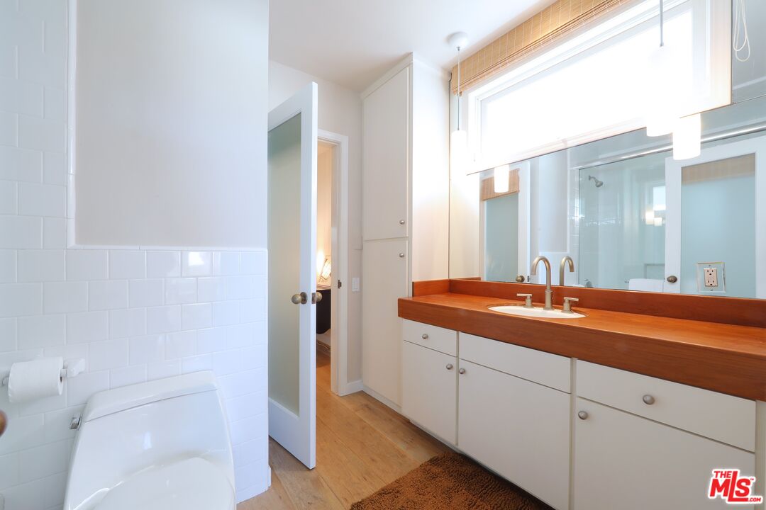 31008 Broad Beach Road Malibu, CA 90265 - Photo 25 of 40 a en suite bathroom with a granite countertop sink and a mirror