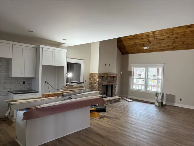 a kitchen with sink refrigerator and cabinets